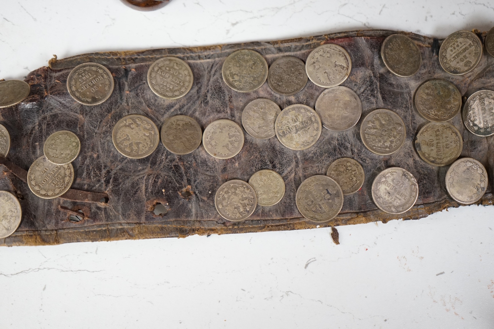 A 19th century Persian silver, niello work and coin mounted belt, dated 1880 (1297 AH in script) and an African sword (broken)